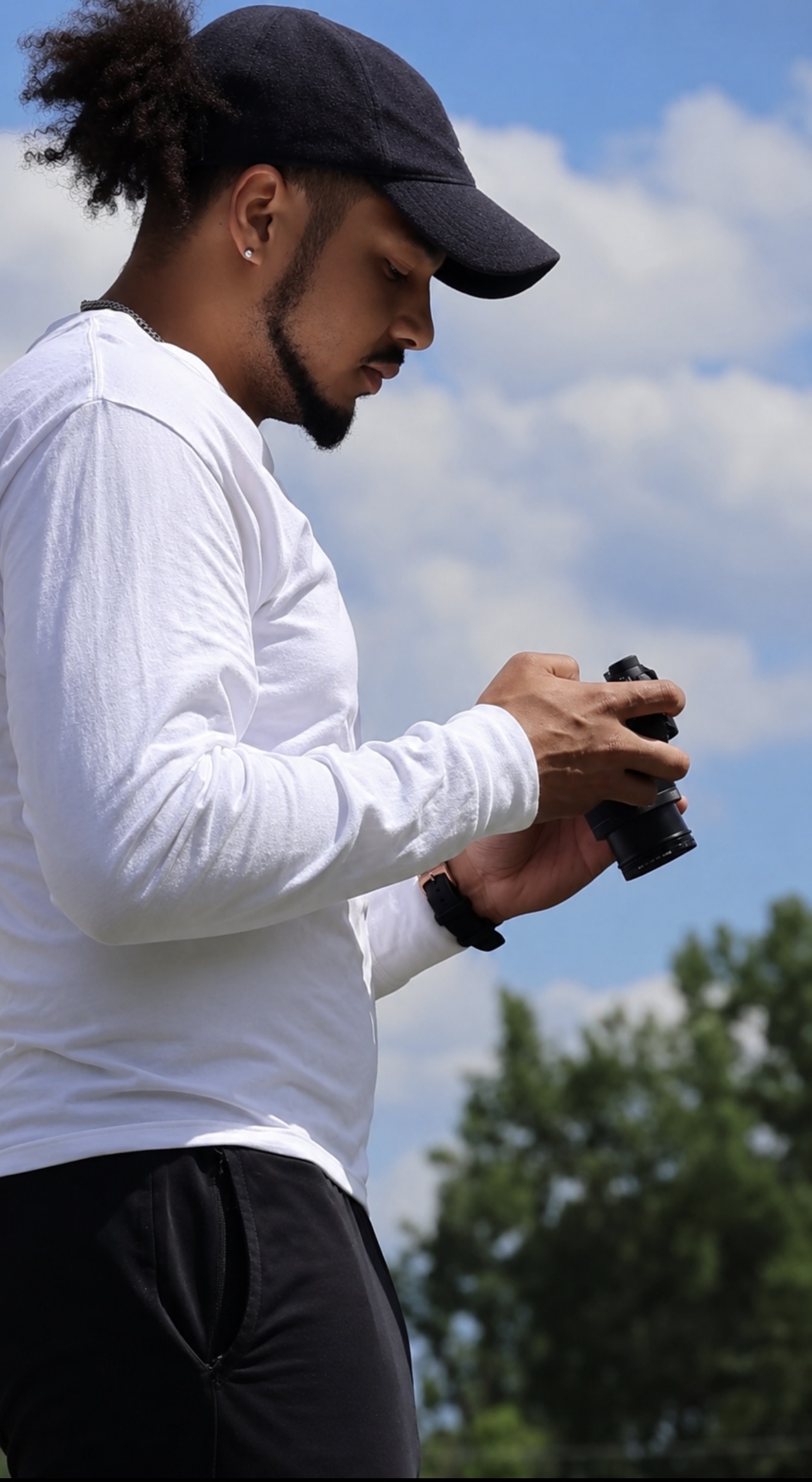 Ryan Hyde adjusting a camera outdoors